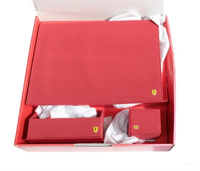 Lot 2084 - Ferrari Interest: An Official Red Leather Three Piece Desk Set, comprising a fold-out writing...