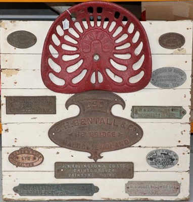 Lot 2136 - Tractor Interest: A Painted Display Board, mounted with a Bamford tractor seat and eleven name...
