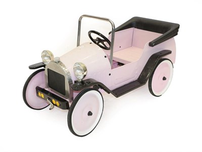 Lot 2207 - A Child's Vintage Style Pink Metal Bodied Pedal Car, with three-spoke steering wheel, solid...