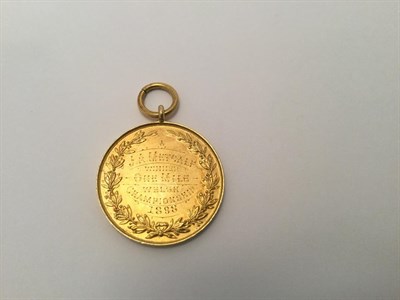 Lot 2044 - A Victorian Gold Medal, Stamped '15ct', Dated 1897, circular the obverse with a shield chased...
