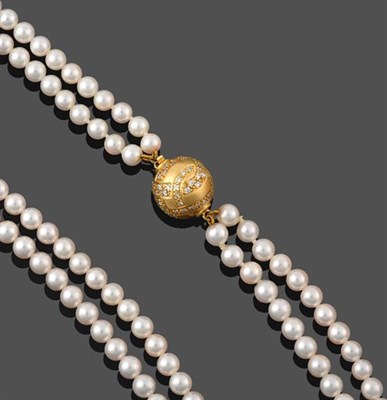 Lot 2155 - A Two Strand Cultured Pearl Necklace, the 91:97 uniform cultured pearls knotted to a yellow...