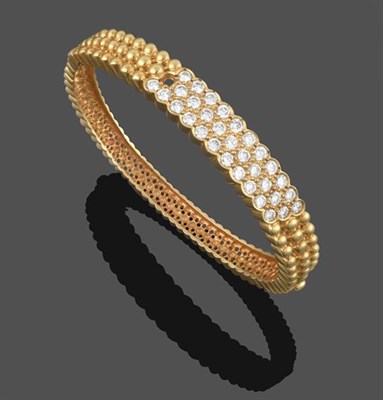 Lot 2156 - A Diamond Bangle, three rows of round brilliant cut diamonds in yellow claw and rubbed over...