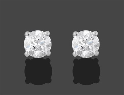 Lot 2165 - A Pair of 18 Carat White Gold Diamond Solitaire Earrings, the round brilliant cut diamonds in...