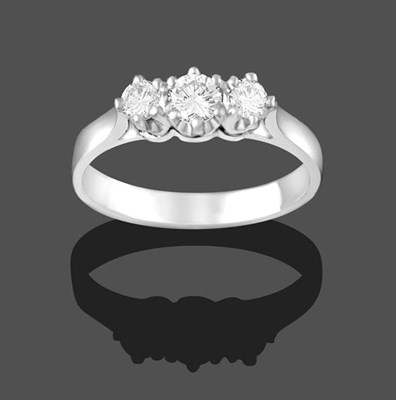 Lot 2167 - A Platinum Diamond Three Stone Ring, the graduated round brilliant cut diamonds in claw...