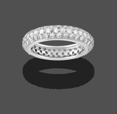 Lot 2175 - A Diamond Bombé Eternity Ring, three rows of round brilliant cut diamonds in white claw...