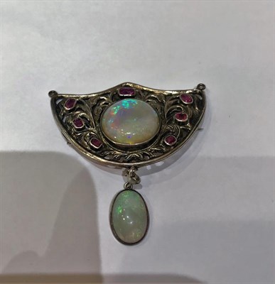Lot 2177 - An Arts & Crafts Style Opal and Ruby Brooch, the shield motif set centrally with a circular...