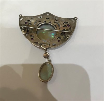 Lot 2177 - An Arts & Crafts Style Opal and Ruby Brooch, the shield motif set centrally with a circular...