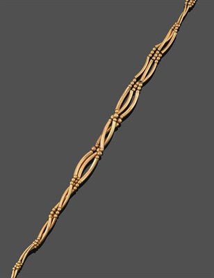 Lot 2185 - A 9 Carat Gold Fancy Link Necklace, formed of three yellow strands of graduated tube links...