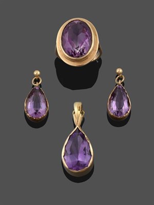 Lot 2187 - A 9 Carat Gold Amethyst Ring, the oval cut amethyst in a yellow rubbed over setting, to a...