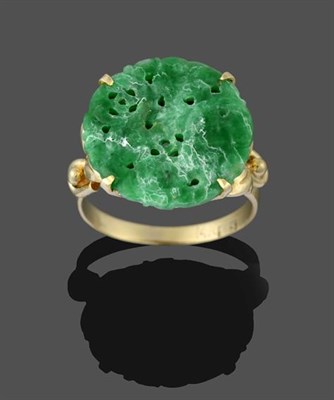 Lot 2194 - A Jadeite Ring, the circular pierced jadeite plaque, in a yellow claw setting, on a plain...