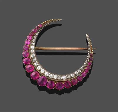 Lot 2198 - A Ruby and Diamond Crescent Brooch, formed of two rows, one of graduated round cut and oval cut...