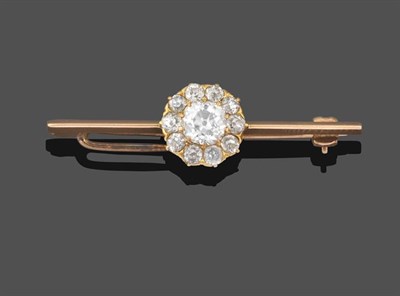 Lot 2201 - A Diamond Cluster Bar Brooch, the old cut diamond within a border of smaller old cut diamonds...