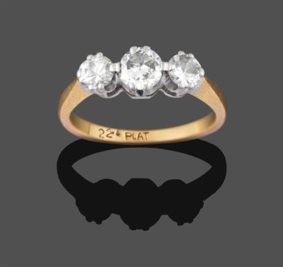 Lot 2202 - A Diamond Three Stone Ring, the graduated round brilliant cut diamonds in white double claw...