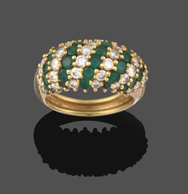 Lot 2203 - An Emerald and Diamond Ring, formed of eleven alternate rows of round brilliant cut diamonds...