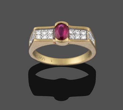 Lot 2205 - A Ruby and Diamond Ring, the oval cut ruby in a yellow claw setting, flanked by two rows of...