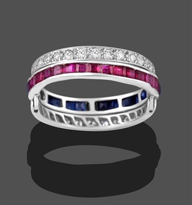 Lot 2209 - A Ruby, Sapphire and Diamond Eternity Swivel Ring, the main band channel set in white with calibré