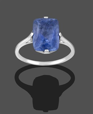 Lot 2210 - A Sapphire Ring, the cushion cut sapphire in a white four claw setting, to a tapered shoulder plain