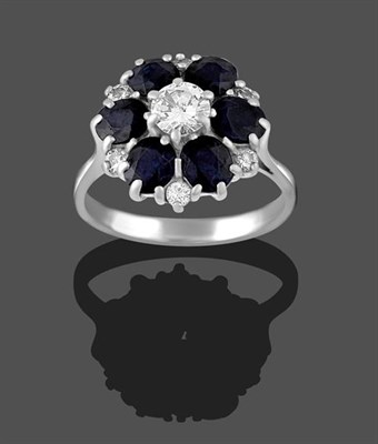 Lot 2222 - A Sapphire and Diamond Cluster Ring, the round brilliant cut diamond within a border of round...