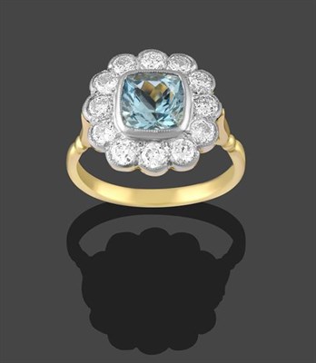 Lot 2227 - An Aquamarine and Diamond Cluster Ring, the cushion cut aquamarine within a border of round...