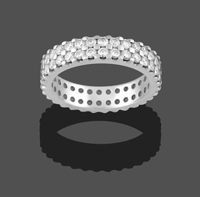Lot 2228 - A Platinum Diamond Eternity Ring, formed of two rows of round brilliant cut diamonds in claw...