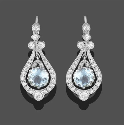 Lot 2230 - A Pair of Aquamarine and Diamond Drop Earrings, the round cut aquamarine in a white claw...