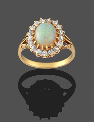 Lot 2240 - An Opal and Diamond Cluster Ring, the oval opal cabochon within a border of old cut diamonds in...