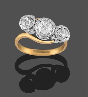 Lot 2254 - A Diamond Three Stone Twist Ring, the old cut diamonds in white millegrain settings, on a...