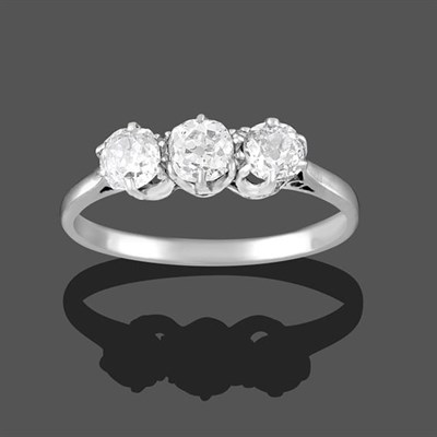 Lot 2259 - A Diamond Three Stone Ring, the old cut diamonds in white claw settings, to a tapered shoulder...