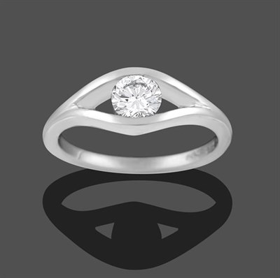 Lot 2269 - A Platinum Diamond Solitaire Ring, the round brilliant cut diamond tension set within a lozenge...