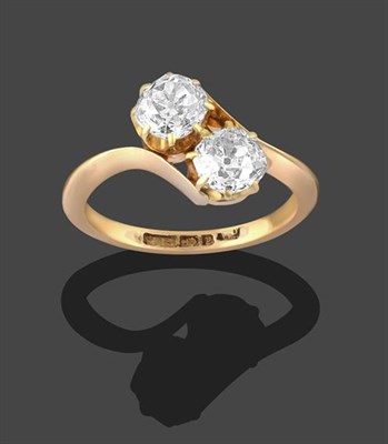Lot 2280 - An 18 Carat Gold Diamond Two Stone Twist Ring, the two old cut diamonds in yellow claw settings, to