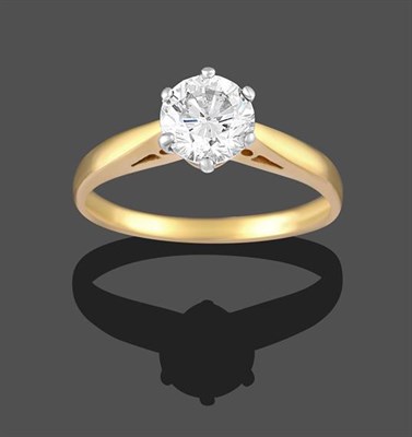 Lot 2283 - A Diamond Solitaire Ring, the round brilliant cut diamond in a white claw setting, to a yellow...