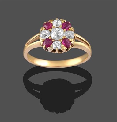 Lot 2287 - A Ruby and Diamond Cluster Ring, the old cut diamond within a border of old cut diamonds and...
