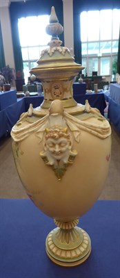 Lot 5 - A Royal Worcester Porcelain Vase and Cover, 1897, the twin mask handles hung with swags,...