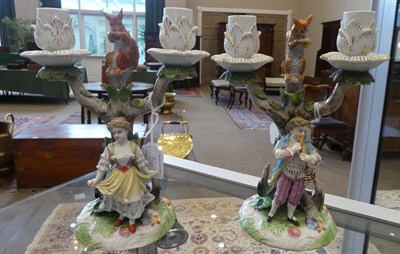 Lot 86 - A Pair of Meissen Style Figural Candelabra, circa 1900, as a boy playing pipes and a girl...