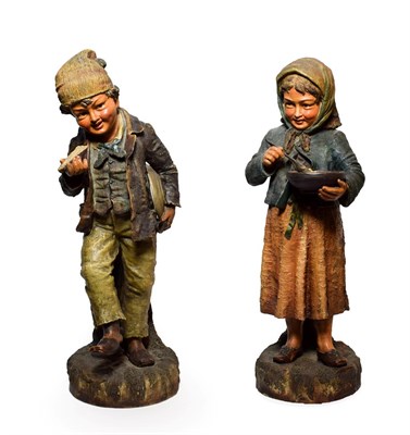 Lot 99 - A Pair of Austrian Painted Terracotta Figures of Urchins, circa 1900, she with a bowl of food...