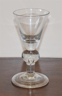 Lot 113 - A Heavy Baluster Wine Glass, circa 1720, the rounded funnel bowl on a teared ball knop, plain...