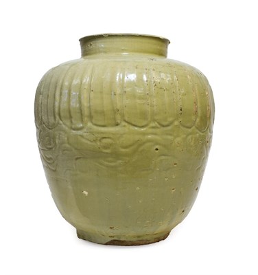 Lot 118 - A Chinese Celadon Glazed Jar, in Song style, of ovoid form, carved with gadroons and waves,...