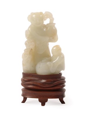 Lot 131 - A Chinese Jade Figure Group, as a figure standing holding a vase of flowers, a child with a...