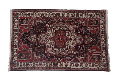 Lot 192 - Bakhtiari Rug West Iran, circa 1970 The charcoal field with central medallion framed by ivory...