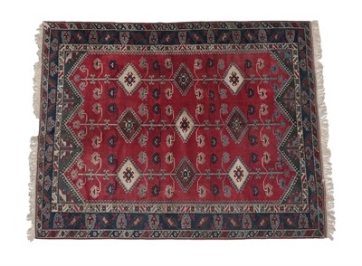 Lot 194 - Yagibedir Carpet West Turkey, circa 1970 The tomato field of hooked medallions enclosed by...