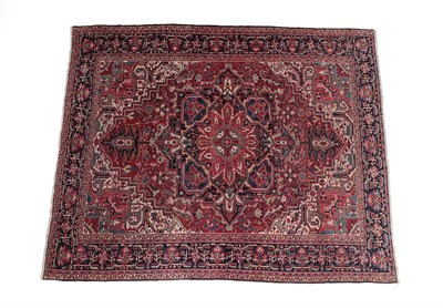 Lot 202 - Heriz Carpet of unusual size North West Iran, circa 1920 The brick red field with typical...