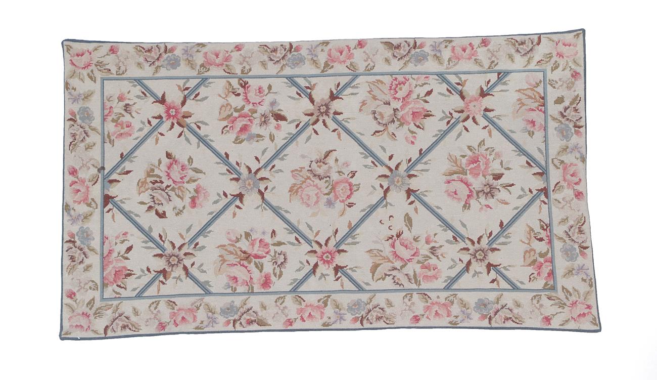 Lot 205 - Modern Chinese Needlepoint Rug The ivory diamond lattice field of naturalistic floral sprays...