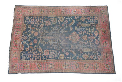 Lot 218 - Ushak Carpet Central Anatolia, circa 1920 The indigo field of stylised trees and plants enclosed by