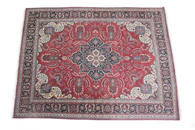 Lot 234 - Tabriz Carpet North West Iran, circa 1950 The brick red field of large flowers and serrated...