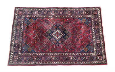 Lot 235 - Joshaghan Carpet Central Iran, circa 1950 The raspberry lattice field of stylised plants centred by