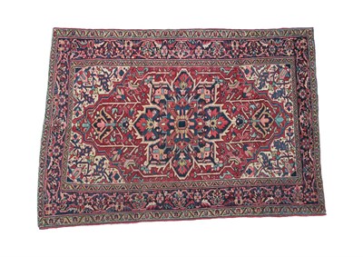 Lot 238 - Heriz Rug of unusual size North West Iran, circa 1920 The tomato red field with typical indigo...