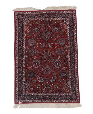 Lot 239 - Kashan design Rug  Indian, 20th century The deep brick red field of flower heads and serrated...