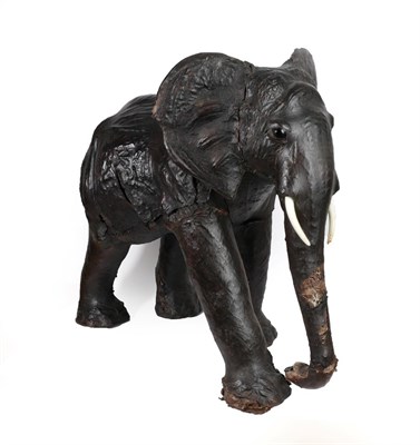 Lot 258 - A Leather Covered Model of a Baby Elephant, possibly Liberty, 20th century, with glass eyes and...