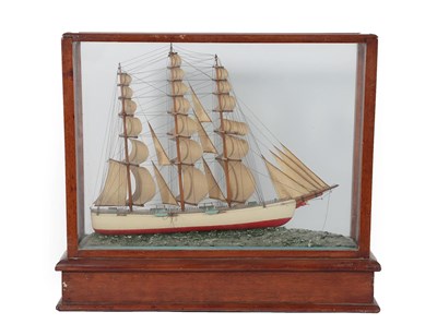 Lot 295 - A Painted Wood Scale Model of a Three-Masted Sailing Ship, early 20th century, in a glazed mahogany