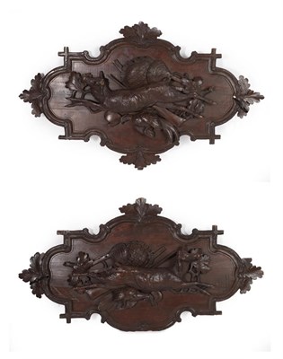 Lot 302 - A Pair of Carved and Stained Limewood Wall Appliques, late 19th century, worked in relief with dead